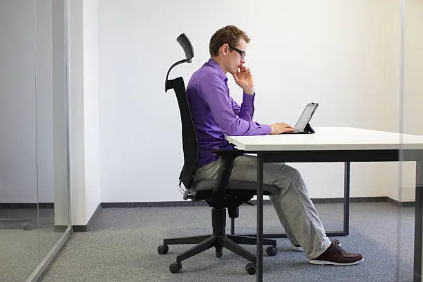 Photo of correct sitting position at desk with tablet