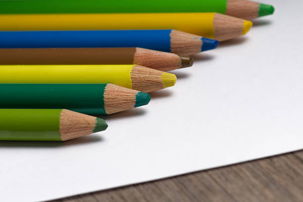 istock coloring pencils top of empty white paper. 186085553