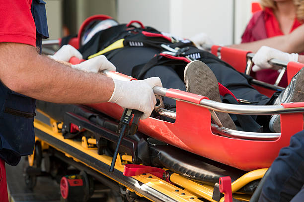 istock Paramedics rushing patient into an ambulance 186085662