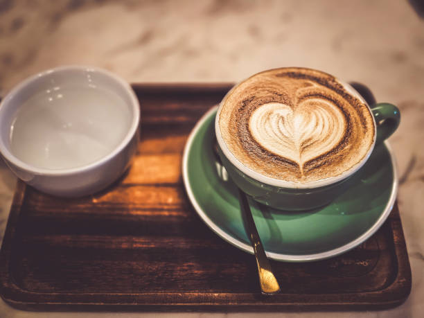 istock Hot cappuccino coffee in a mug Placed on the table in a warm atmosphere. 1860907323