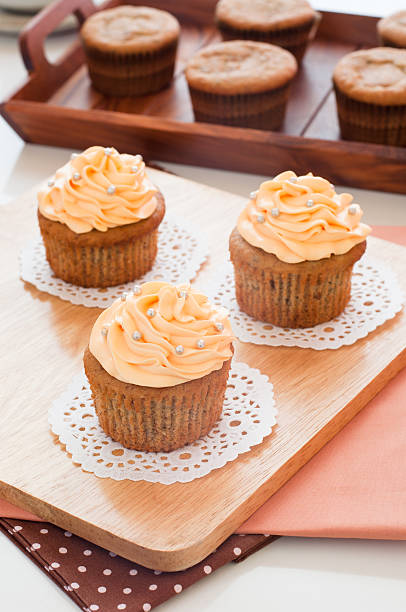 Homemade cupcakes served on kitchen table. stock photo
