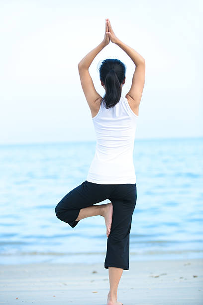 istock yoga woman seaside 186094428