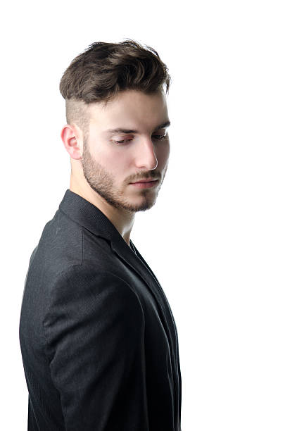 istock Attractive young man in suit, looking down 186094961