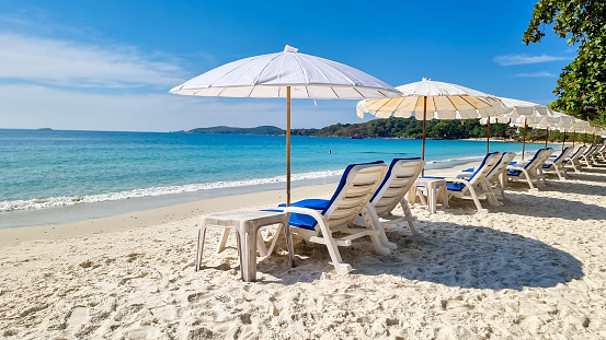 Koh Samet Island Rayong Thailand, beach chairs sunbed with umbrellas at the white tropical beach of Samed Island with a turqouse colored ocean