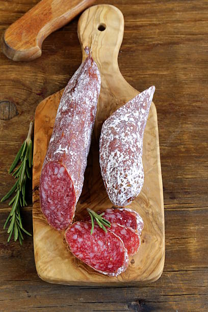 istock delicacy smoked sausage (pepperoni) on a cutting board 186096055
