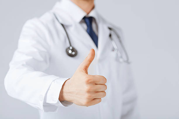 istock male doctor hand showing thumbs up 186096322