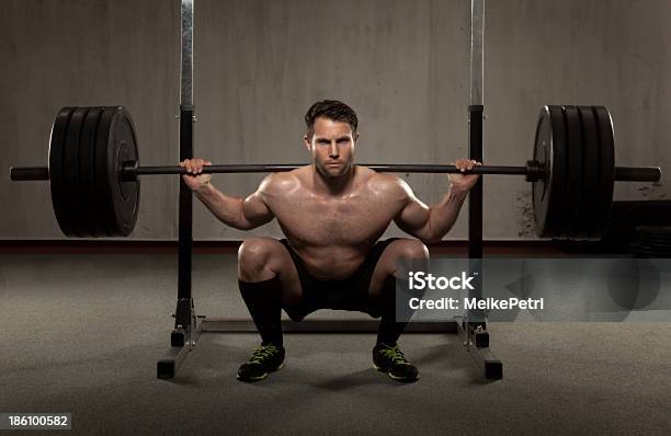 Athlete Performing Squat With Barbell Stock Photo - Download Image Now - Active Lifestyle, Agility, Anaerobic Exercise