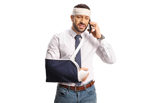 Injured man using a smartphone isolated on white background