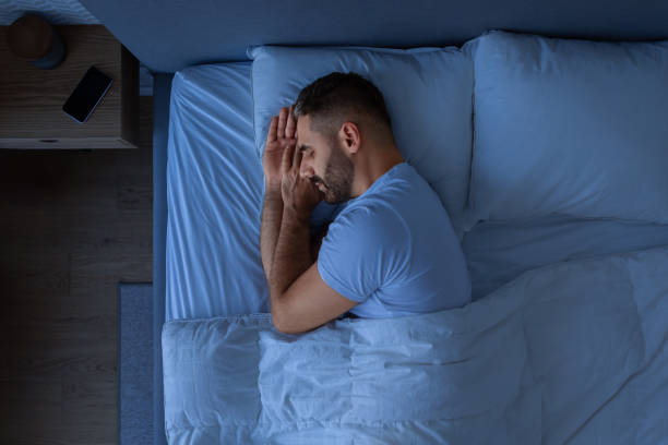 istock Guy Sleeping Holding Hands Near Face Enjoying Rest In Bedroom 1861017891