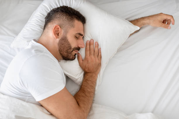 istock Caucasian man lying in comfy bed taking peaceful nap indoor 1861018417