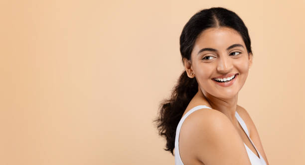 istock Beauty Ad. Smiling Indian Woman Looking At Copy Space Behind Her Back 1861020653