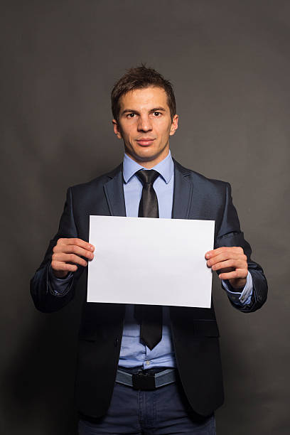 istock Businessman Holding a Blank Sign 186102611