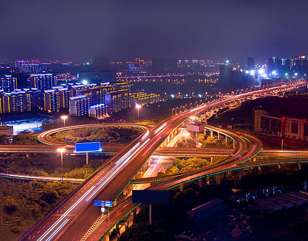 istock Freeway in night with cars light at modern city 186103086