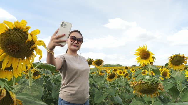 Point of view Woman among sunflowers in the field.