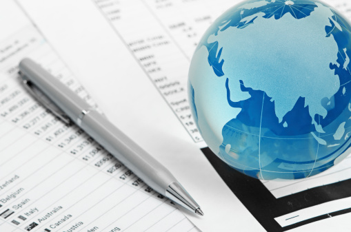 Glass globe and pen on finance