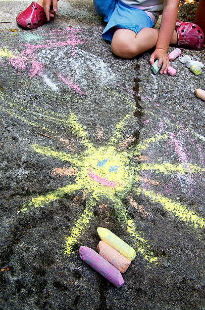 Childs painting on the pavement stock photo