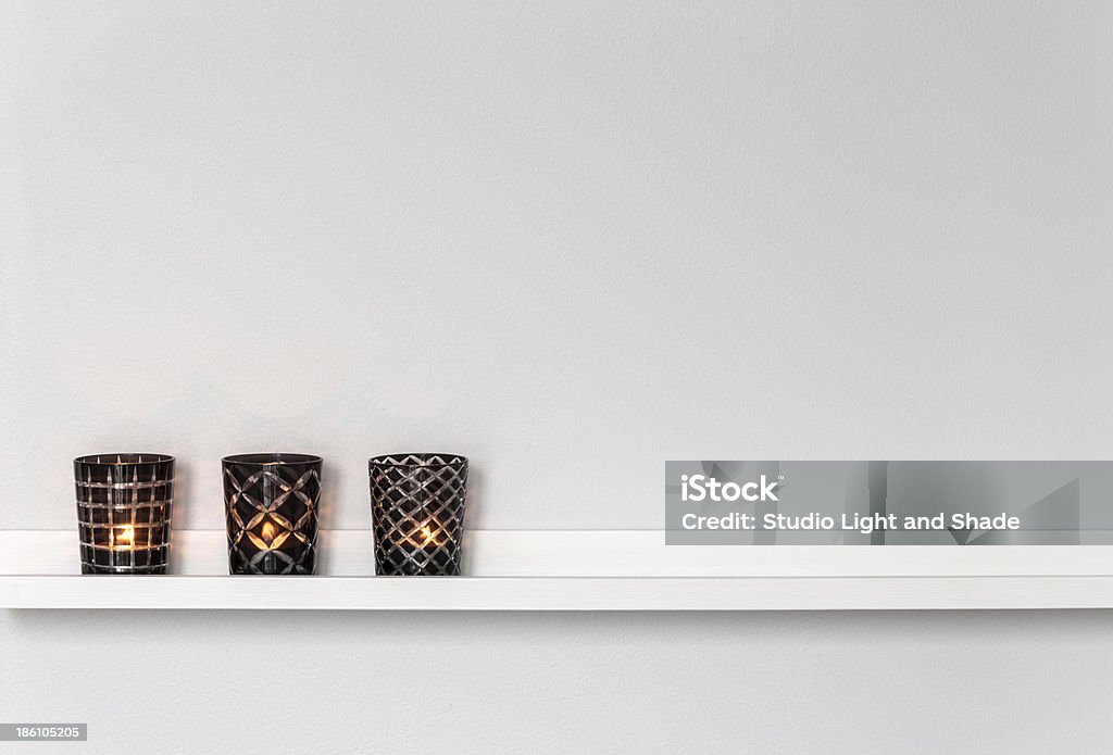 Candle lights on white shelf Home decor, candle lights on a white shelf. Candlestick Holder Stock Photo