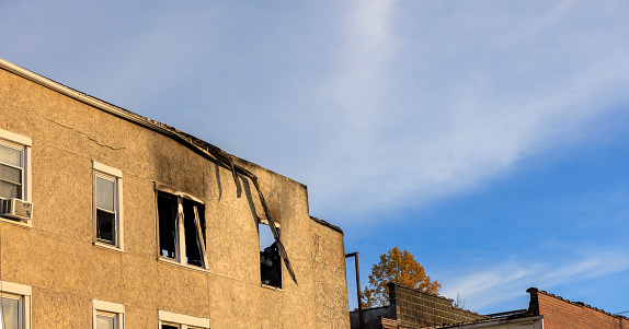 Fire aftermath in residential area of Bangor, Pennsylvania. Burnt-out building with broken windows after a fire disaster