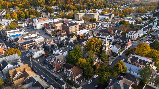 Historical neighborhood in Bangor, Pennsylvania: small neighborhood, nestled among autumnal trees. Fall season covers the sunny townscape