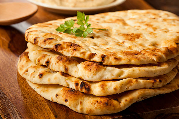 istock Homemade Indian Naan flatbread stacked on a cutting board 186108434