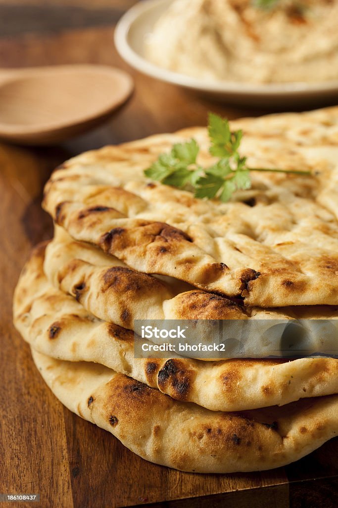 Homemade Indian Naan Flatbread Homemade Indian Naan Flatbread made with Whole Wheat Baked Stock Photo