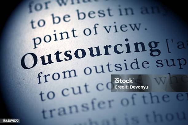 The Word Outsourcing In The Dictionary Stock Photo - Download Image Now - Dictionary, Outsourcing, Blue