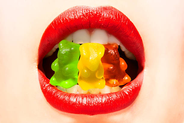 istock Woman eating candy colors 186115201