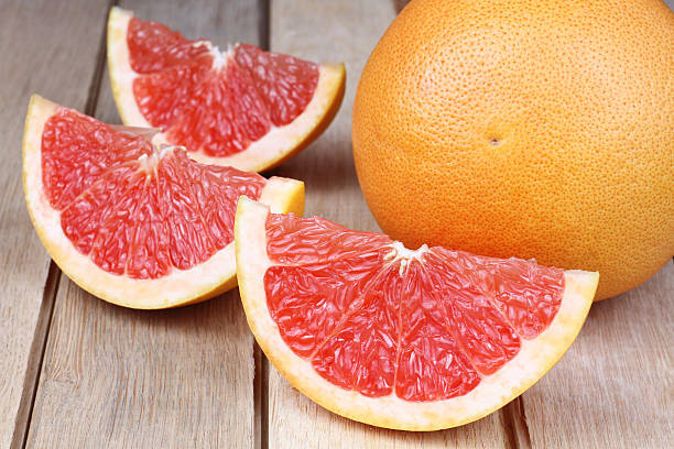 istock Sliced red grapefruit on a wooden background 186119420