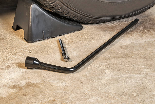istock Tire iron, pressure gauge and wheel chock in a garage 186119582