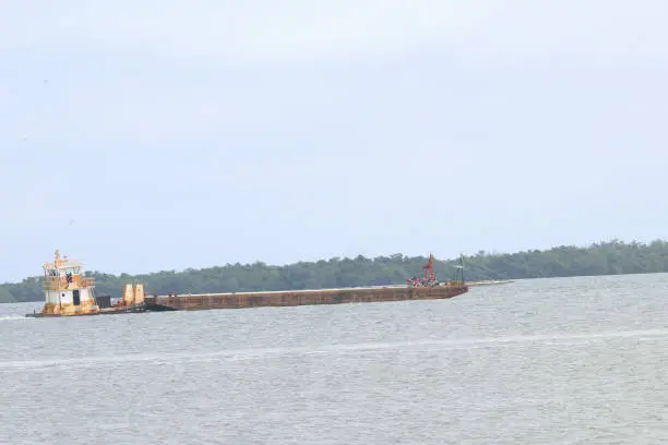 Barge being pushed by a tug boat on the  Caribbean sea.