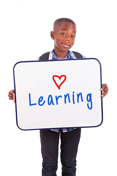 istock African American school boy holding a blank board 186119992