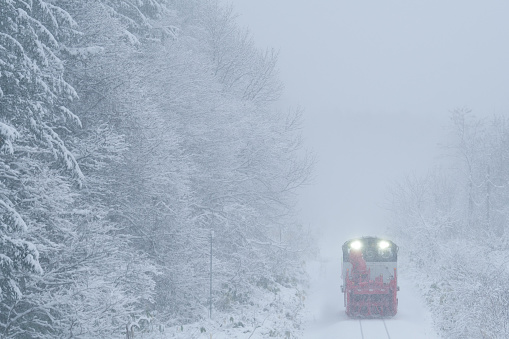 Nikii-cho, Hokkaido, Japan - December 17, 2023 : Snow removal train running on straight line