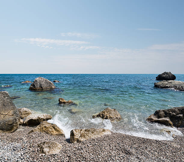 Black sea with stony beach and beautiful clouds