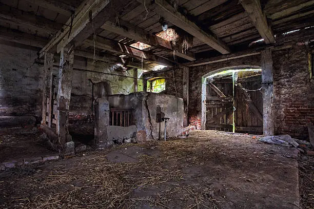 Photo of Interior of an old, decaying barn.