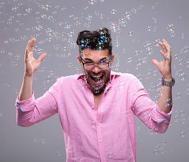 istock young fashion man goes crazy among bubbles 186122731