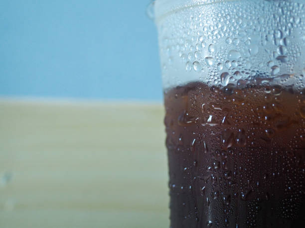Iced black coffee steam in the cup close-up