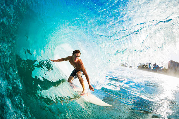 close-up of a surfer riding a large blue wave - tropical surf stockfoto's en -beelden