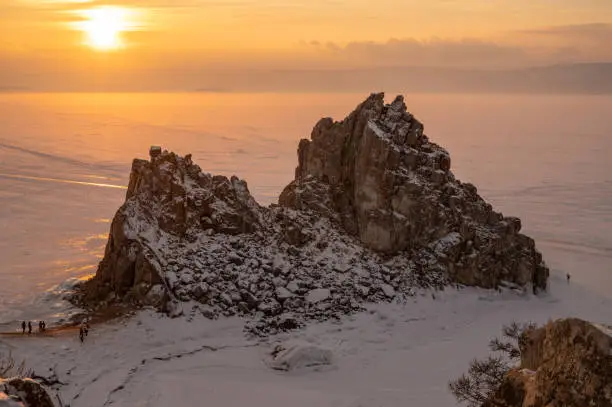 Photo of The Shaman rock one of sacred place in frozen lake Baikal in winter season of Siberia, Russia during sunse.