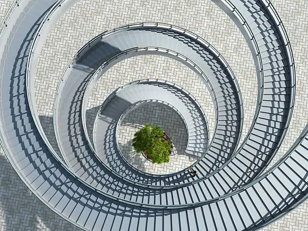 Photo of Aerial view of a spiral staircase with a tree in the middle