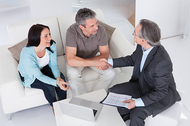 Couple Meeting Consultant Happy Couple And Mature Consultant Discussing Together tax planning discussion stock pictures, royalty-free photos  images