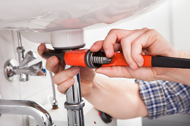 istock Young plumber fixing a sink in bathroom 186130754