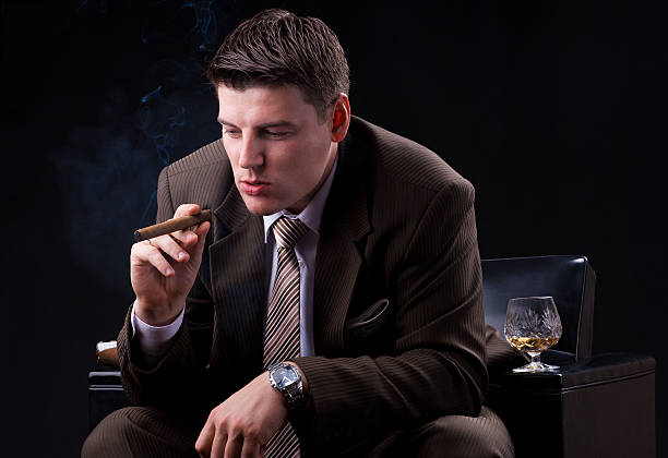istock Rich Young businessman smoking a cigar 186131155