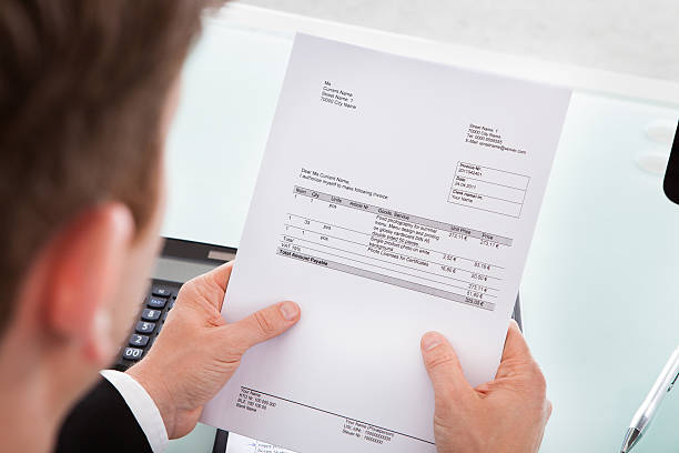 istock Businessman holding invoice paper 186131431