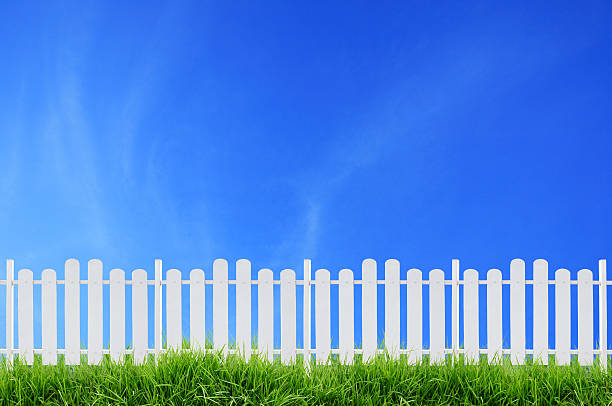 istock white fence and blue sky 186131535