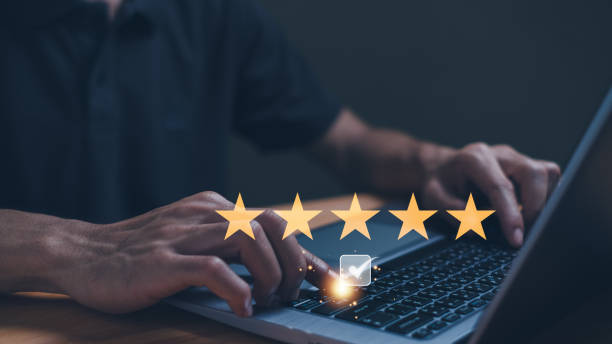 istock Customer service experience and business satisfaction survey, close up  hand using smart phone and give five star symbol to increase rating of product and service concept. 1861316022