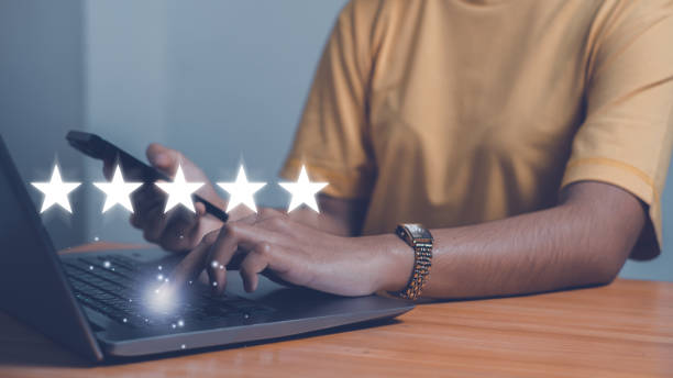 istock Customer service experience and business satisfaction survey, close up  hand using smart phone and give five star symbol to increase rating of product and service concept. 1861316025