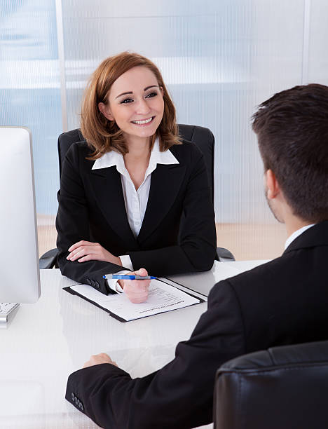 istock A female sitting at a desk taking notes in a conversation  186131843