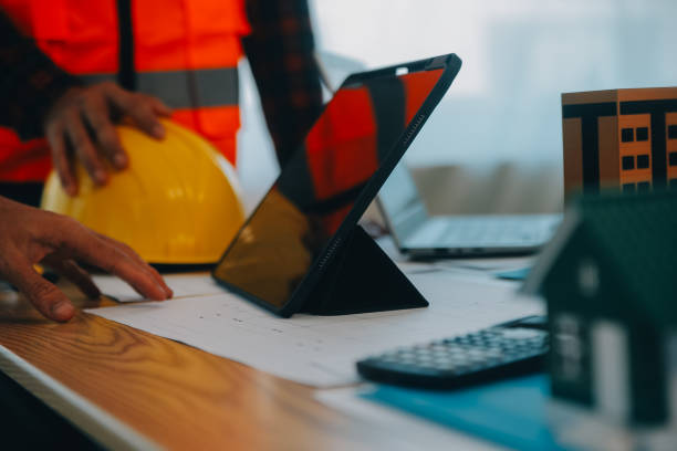 istock Construction and structure concept of Engineer or architect meeting for project working with partner and engineering tools on model building and blueprint in working site, contract for both companies. 1861321096