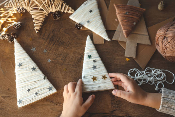 istock Child makes Christmas decoration from yarn 1861332524