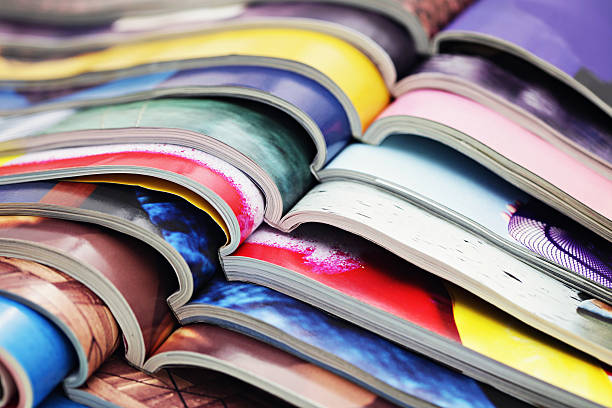 stack of magazines stack of magazines - information magazine publication photos stock pictures, royalty-free photos & images